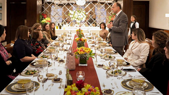 0623itn04 Ambassador Henry T. Wooster (standing, right) welcomes guests to a Ramadan iftar at his residence celebrating the achievements of Jordanian women in the fashion industry, March 29. Among the guests were fashion designers, educators, stylists, runway show creators, influencers, photographers, and the owner and staff of a museum dedicated to Levantine women’s cultural identity preservation. Photo by Dana Haddadin