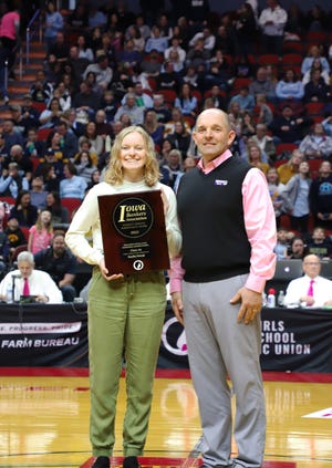 Nick Reggio, vice president Grimes market manager at Charter Bank in Grimes, presents the 2022 IBA Student Athlete Achievement Award to Dallas Center-Grimes High School’s Kaylin Petrak during the 2022 girls basketball state tournament in Des Moines.
