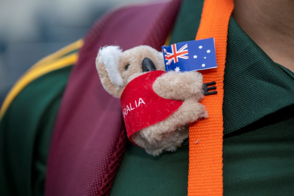 A koala pin from Team Australia on an orange lanyard.