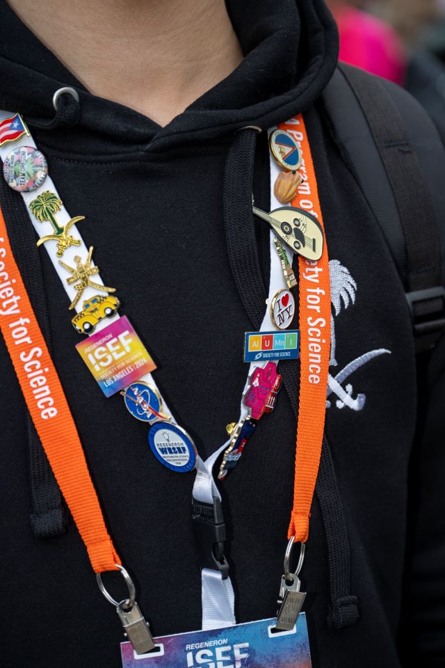 A finalists lanyard filled with pins.