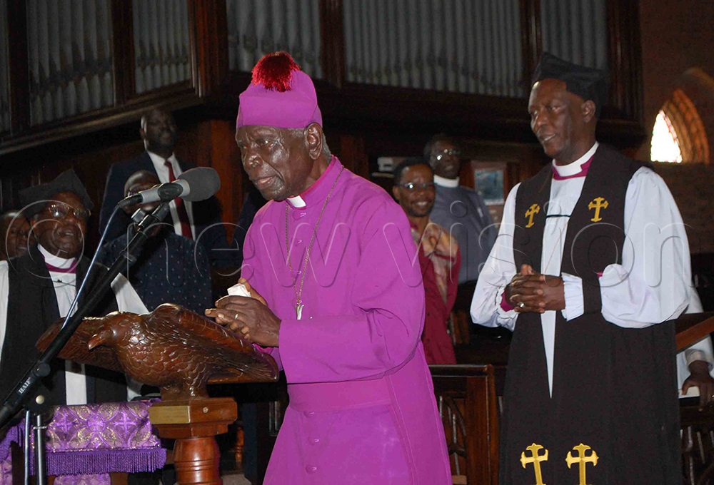 Bishop Emeritus George Sinabulya (behind microphone) singing a farewell song for Bishjop Micahel Senyimba during the latters memorial service at Namirembe Cathedral on Thursday. (Photo by Mathias Mazinga)