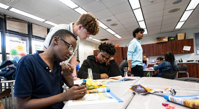 Noah Moon, CEO of Creating Role Models and Mentors, jokes with Fort Myers Middle Academy student Adrian Fernandez during an afterschool session at the school on Wednesday, March 6, 2024. Noah plans on continuing the program once his brother, Dylan, goes to college. The program is expanding to other Lee County schools.