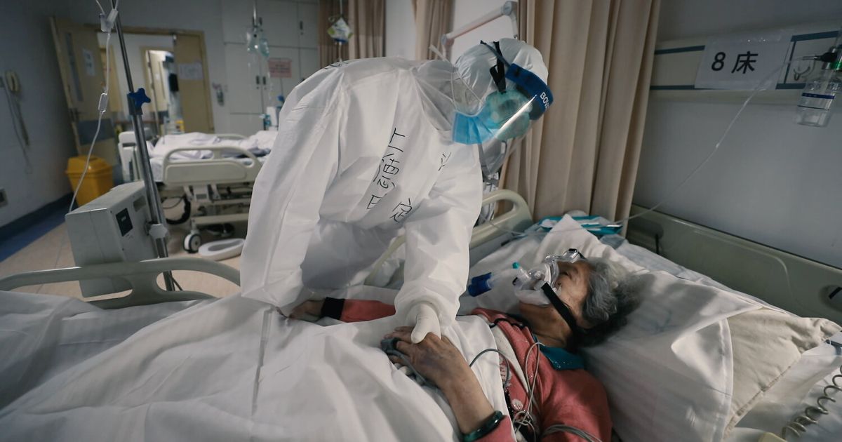 A doctor tends to a patient in 76 Days