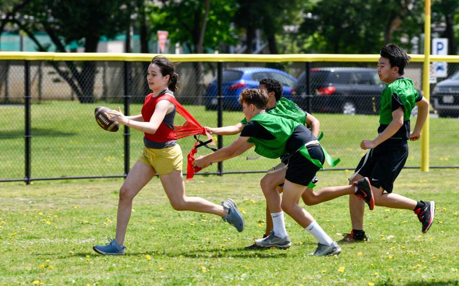 Yokota Middle School and Fussa Dai-ichi Junior High School students participate in a flag football match at the eastside baseball stadium during the Sports Cultural Exchange Program kick-off event at Yokota Air Base, Japan, April 20, 2024. The students were cheered on by family, Yokota Air Base leadership, school faculty members and representatives from the Ministry of Foreign Affairs in Japan as they carried out plays and ran for touchdowns.
