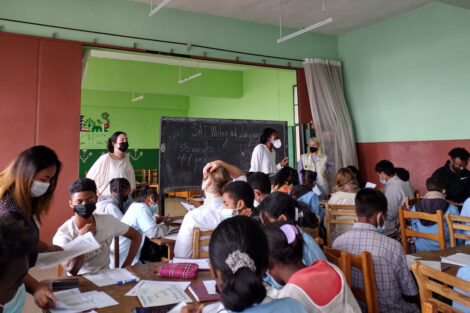 Lafayette mentors stand in front of the class at Lycée Andohalo in Antananarivo, Madagascar.