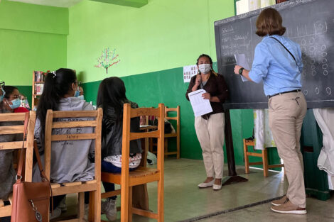 LIME mentors stand at the blackboard in the classroom at Lycee Andahalo