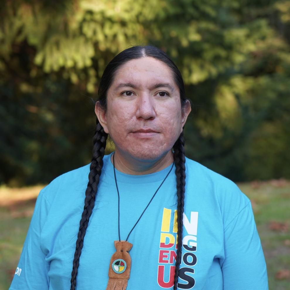 Michael Running Wolf, Ph.D. student at McGill University in Quebec, Canada, is an indigenous man with two braids and a teal t-shirt.