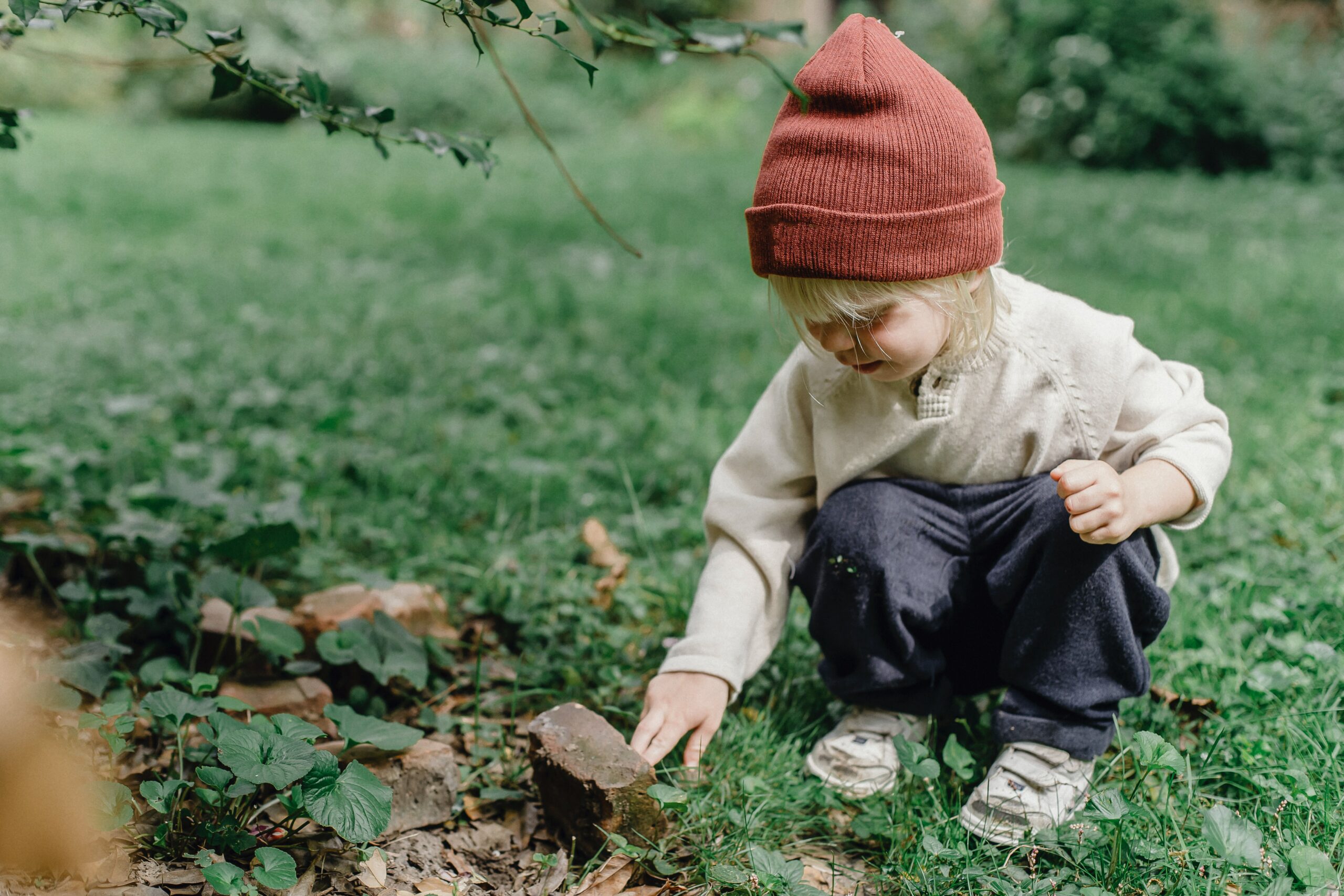 Child looking at a rock
