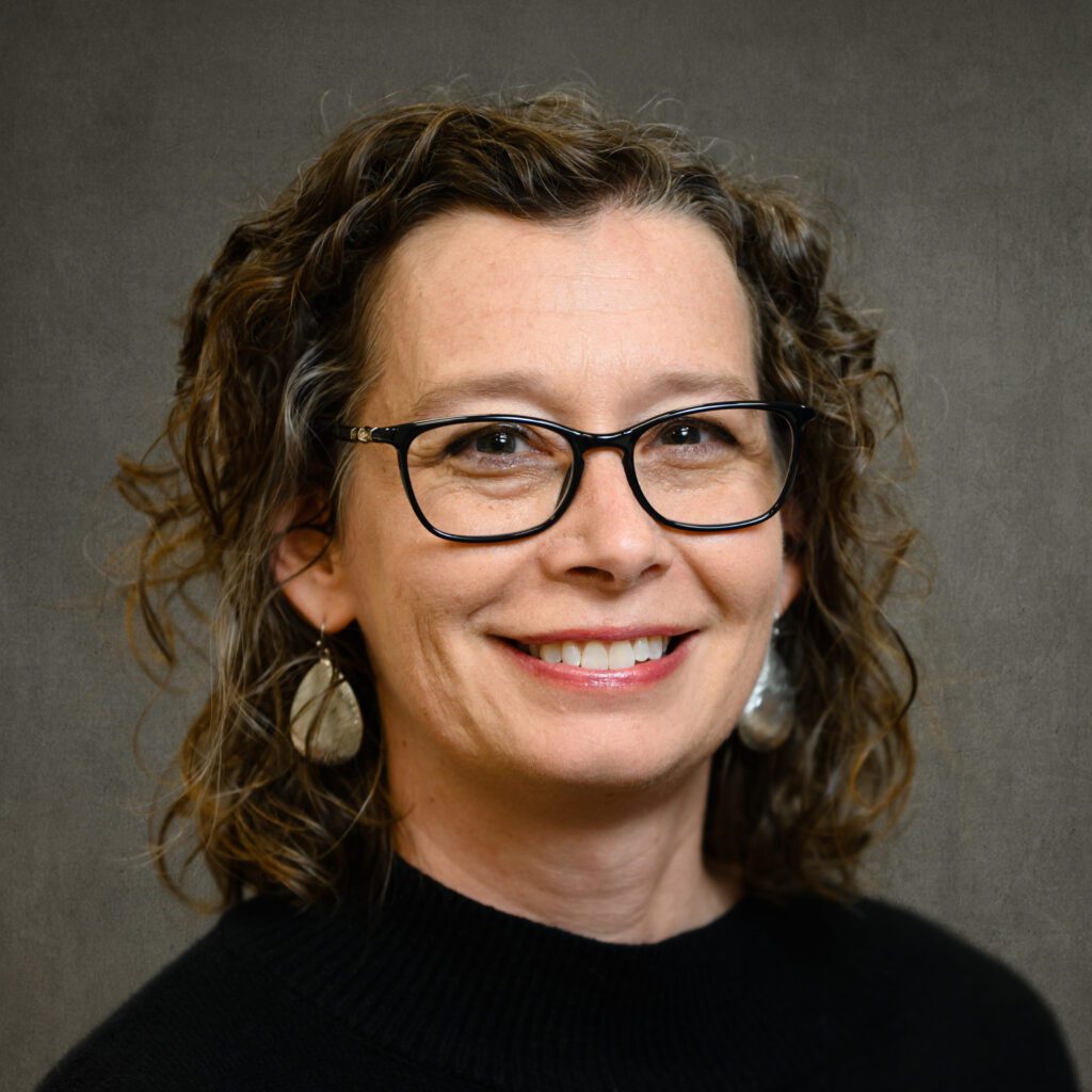 A woman wearing black glasses