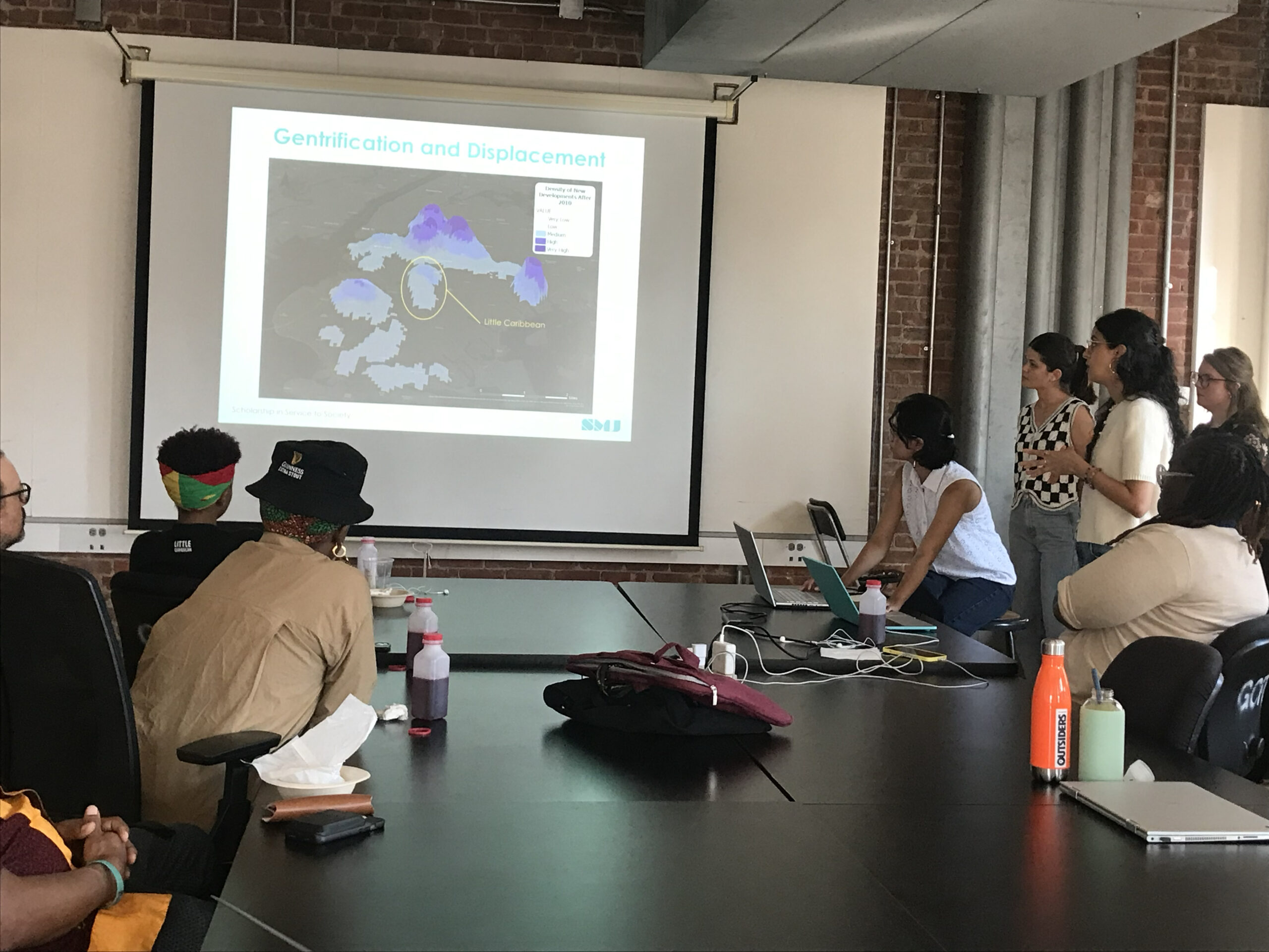 Students in the “Little Caribbean Cultural Resource Survey” class giving their final presentation to Little Caribbean community members. Photograph by Vicki Weiner, academic director of Historic Preservation.