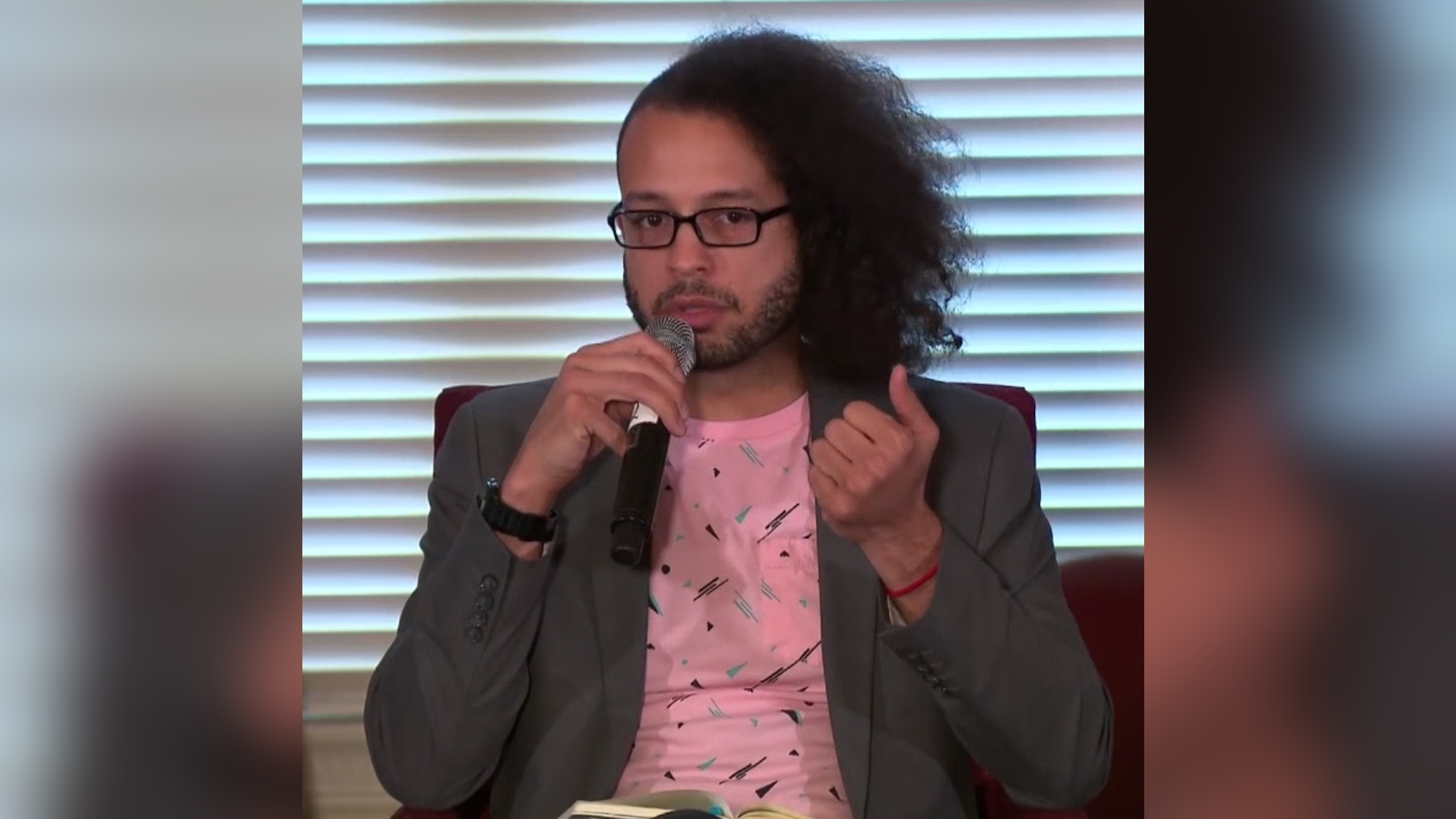 Astrophysicist Brian Nord speaking at the Becoming Interplanetary seminar in 2018.