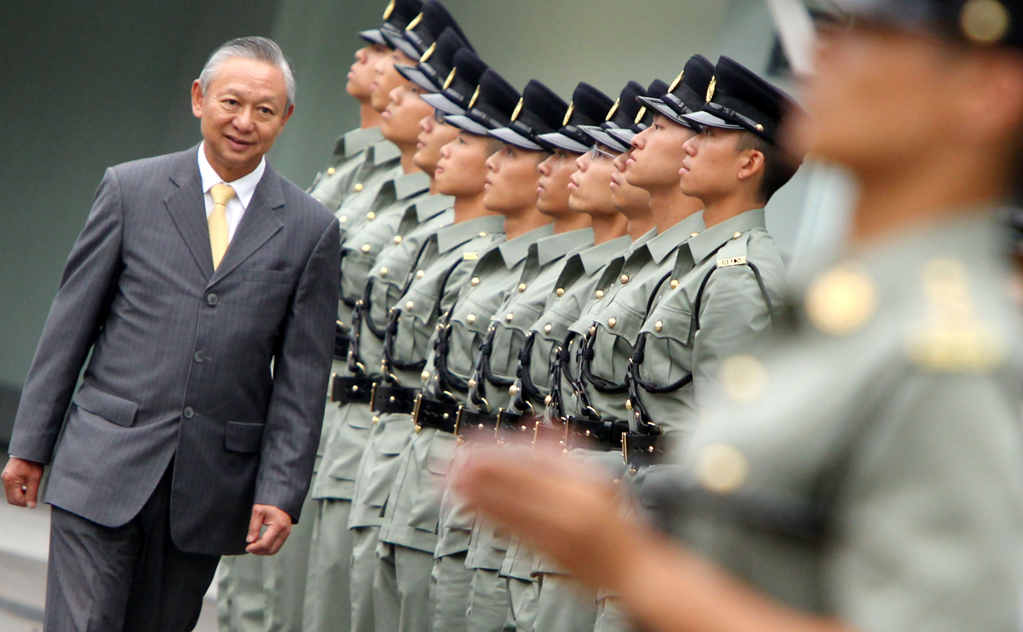 Ambrose Lee inspects officers of the Correctional Services Department in 2012. Photo: SCMP