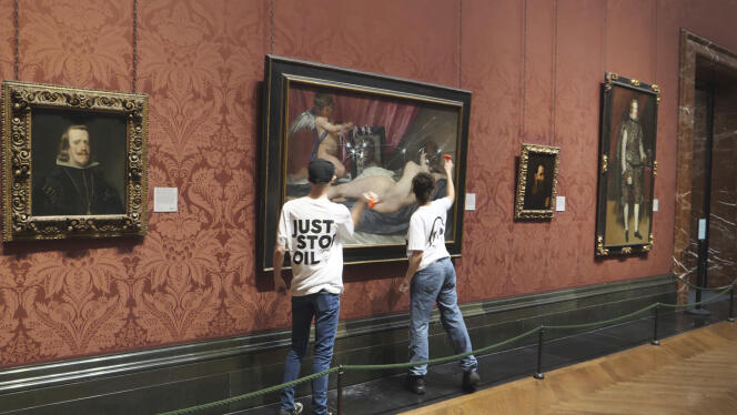 In this photo provided by Just Stop Oil on Monday, November 6, 2023, activists smash the protective glass on a painting at the National Portrait Gallery in London