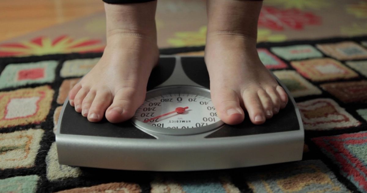 Feet on a scale are seen in Fed Up