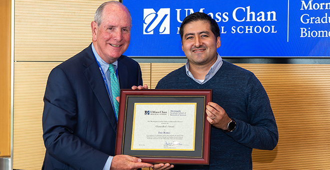 Chancellor Michael F. Collins standing next to Eric Romo