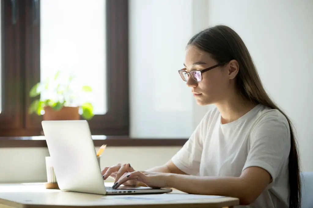 A female high school senior is typing