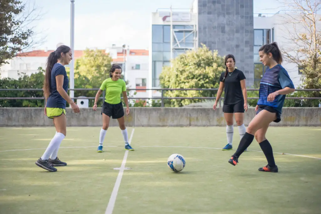 A group of four female high school soccer players thinking about how to find scholarships for college based on their athletic merits