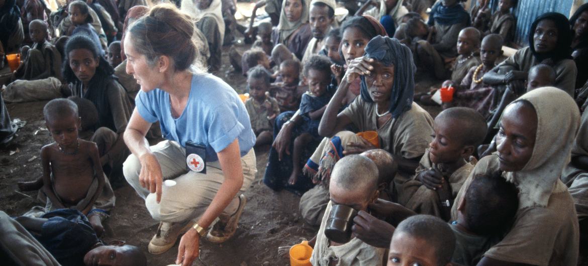 A young British Red Cross worker assists drought victims at a camp in Bati, Ethiopia in 1984. A young British Red Cross worker assists drought victims at a camp in Bati, Ethiopia in 1984.