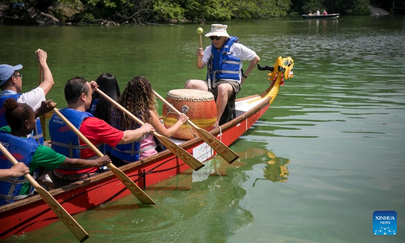 People take an inaugural ride during a dragon eye dotting ceremony of Hong Kong Dragon Boat Festival in Central Park in New York, the United States, on July 20, 2023. A dragon eye dotting ceremony was held in New York City, the United States, on Thursday as a prelude to the 2023 Hong Kong Dragon Boat Festival, which is scheduled for next month.(Photo: Xinhua)