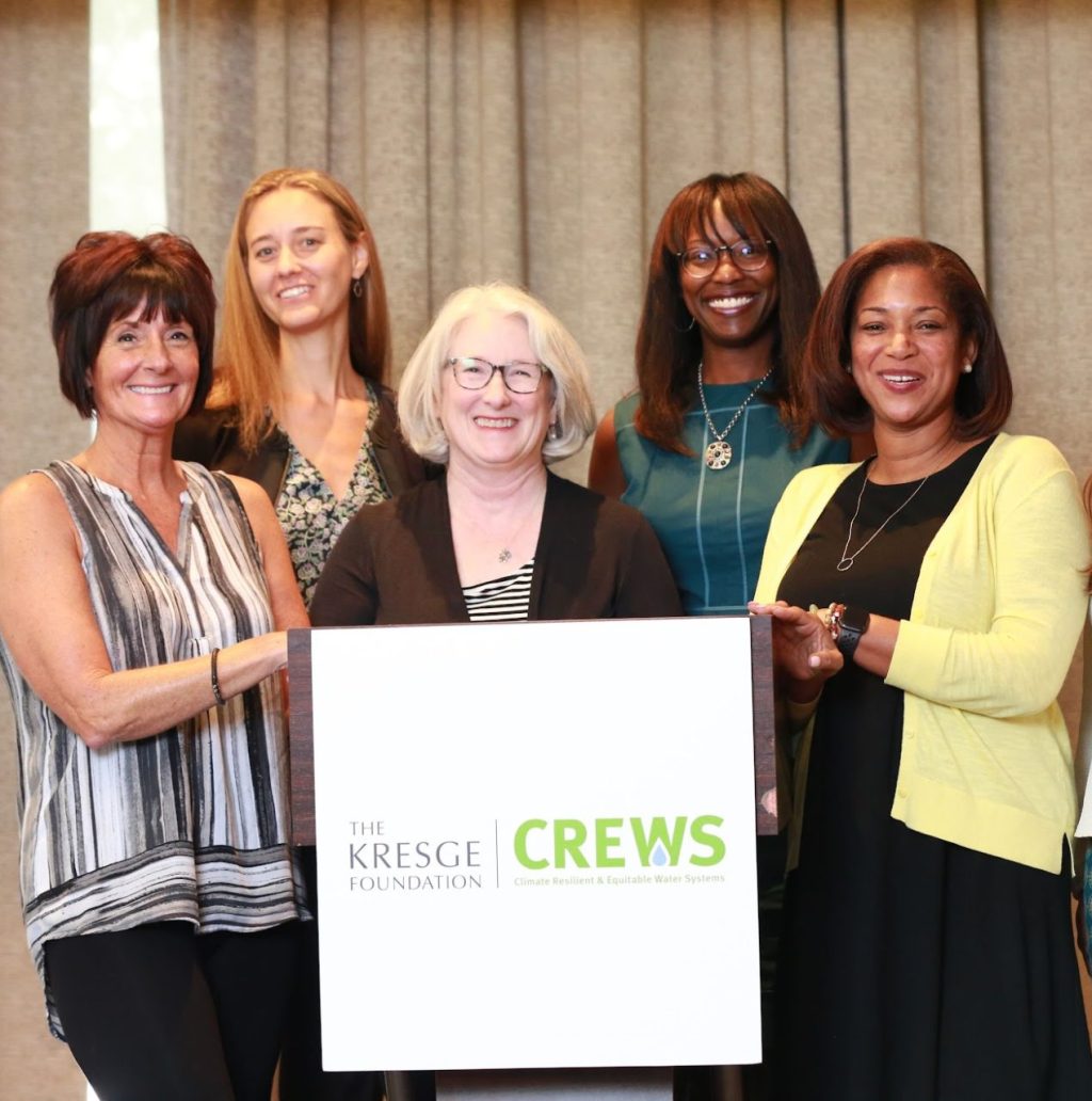 A group of people pose in front of a sign that reads The Kresge Foundation CREWS.