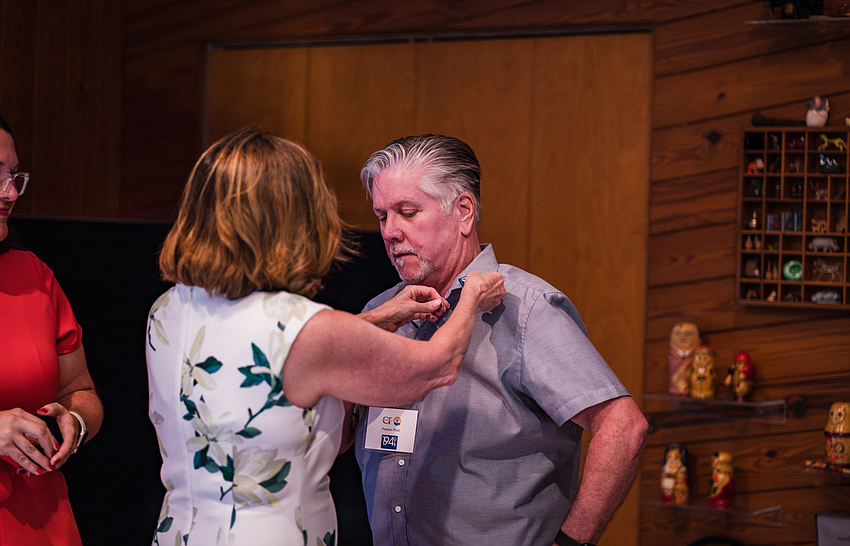 Preston Root is pinned by President and CEO of United Way Florida Melissa Nelson. Courtesy photo
