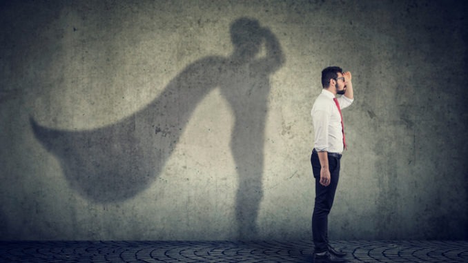 man imagining to be a super hero looking aspired