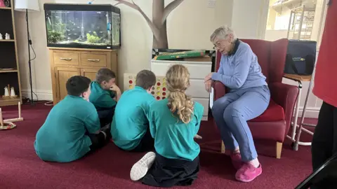 Supplied Children and an elderly person