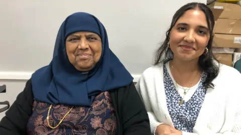 Aisha Iqbal/BBC Sabera Laher, 71, is one of many Batley women whose stories are captured in new book Our Heritage 2. She is pictured with granddaughter Zahra, 17.