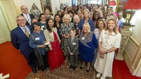 National Literacy Trust Jayden pictured with Queen Camilla and other attendants