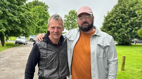 Maddox Jones Stuart Pearce with short hair standing next to Maddox Jones with dark hair and beard