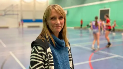 Gwenda, a mum of three, looks at the camera