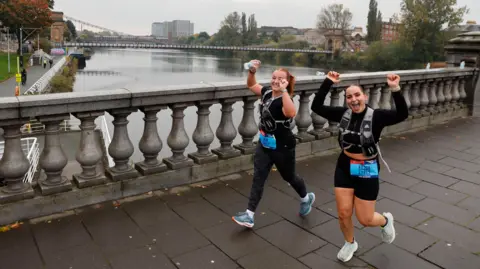 AJ Bell Great Scottish Run Two females runners going over a bridge in Glasgow