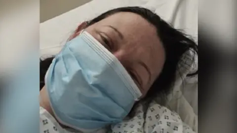 Shelly Sutton Shelly in hospital with a mask on