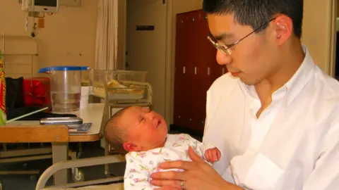 Jonathan Scott-Lee Caitlyn Scott-Lee as a baby being held by her father