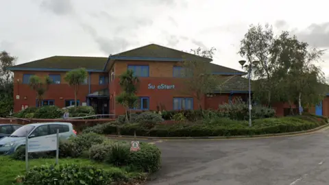 Google A children's centre under a grey sky.