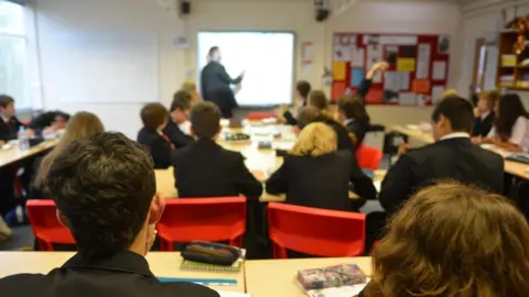 BBC Teacher using white board during lesson