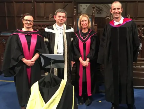 University of Glasgow Senior Glasgow University staff with the robot