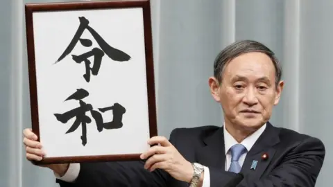 Reuters Mr Suga was nicknamed "Uncle Reiwa" after unveiling Japan's new era name