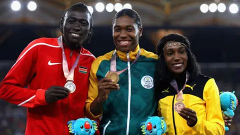 AFP L-R) Silver medalist Margaret Nyairera Wambui of Kenya, gold medalist Caster Semenya of South Africa and bronze medalist Natoya Goule of Jamaica pose during the medal ceremony for the Womens 800 metres during athletics on day nine of the Gold Coast 2018 Commonwealth Games at Carrara Stadium