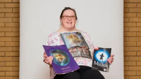 Emile Holba Marie Alderman holding her theatre programmes
