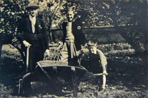  Jim Wilson Jim Wilson with his father and brother in a garden