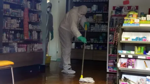 EPA/WILL OLIVER Workers inside a closed GP surgery in Brighton