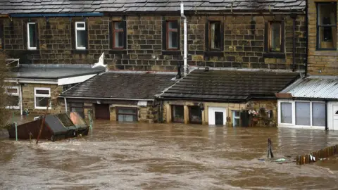 OLI SCARFF/AFP Flooded homes in Mytholmroyd, in West Yorkshire after the River Calder burst its banks during Storm Ciara