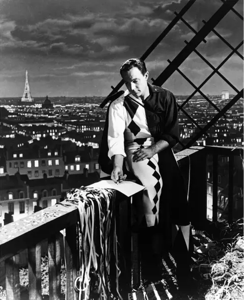Silver Screen Collection An American in Paris, starring Gene Kelly, was filmed on a sound stage with a painted backdrop of the city