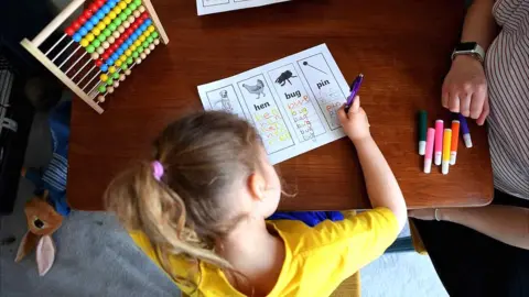 Getty Images Four year old home schooling doing home schooling