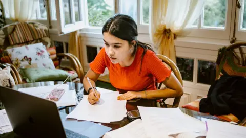 Getty Images A girl studies at home
