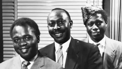 Conrad Bryan Dr Conrad Kanda Koza (centre)