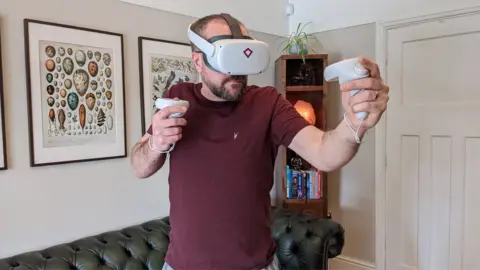 BrightCarbon John Bevan enjoys rock climbing in virtual reality using a headset gifted by his employer