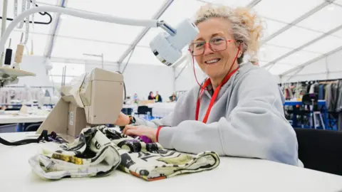 Birmingham 2022 Volunteer sewing costumes