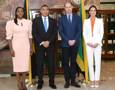 EPA Prince William and Catherine, the Duchess of Cambridge (as they were then) pose with Jamaican Prime Minister Andrew Holness and his wife Juliet during their meeting at the PM's residence in Kingston on 23 March 2022. None are smiling except William.